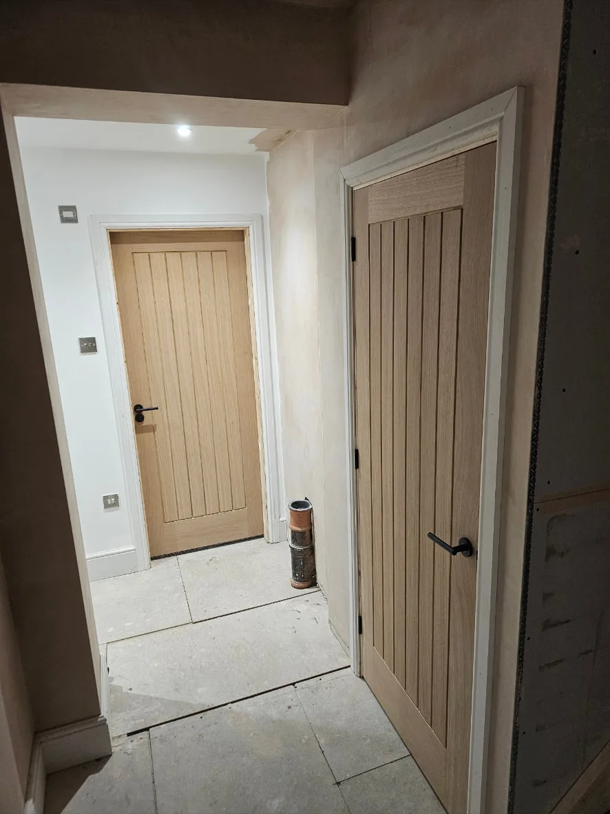 Further view of the hung oak doors from the adjoining hallway